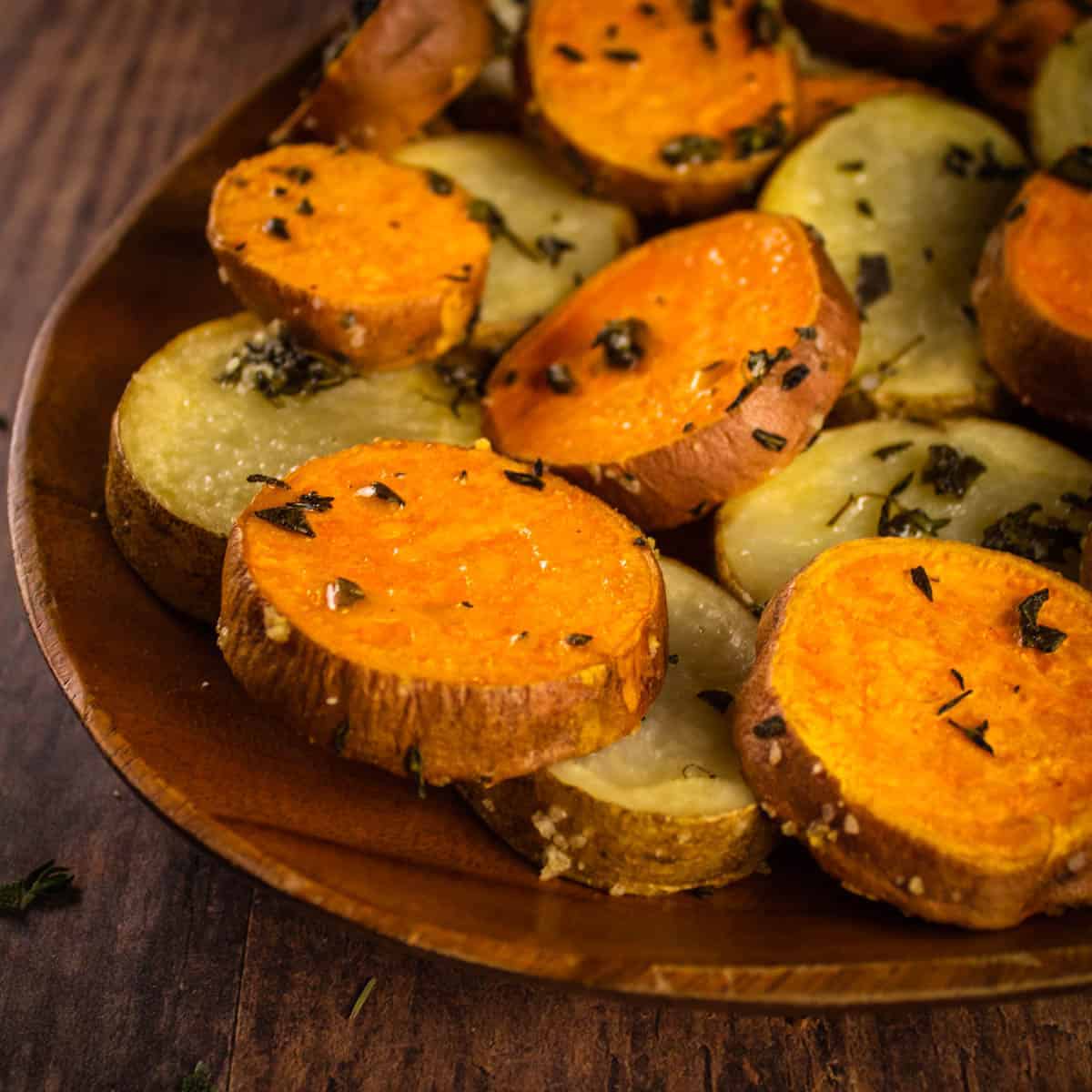 roasted sweet and russet potato slices with fresh herbs