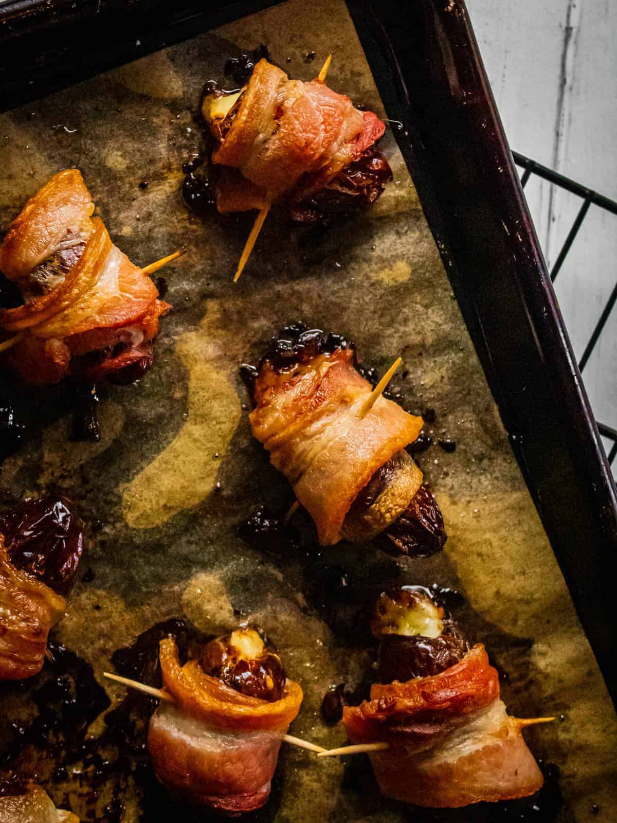 bacon wrapped dates on a sheet pan