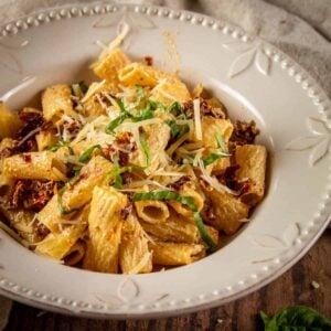 bowl of rigatoni with sundried tomatoes and fresh basil