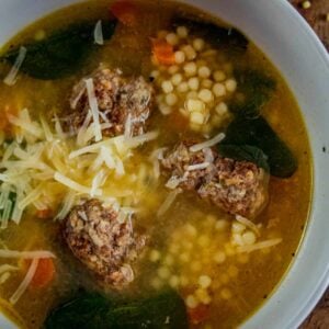 bowl of italian wedding soup with parmesan on top