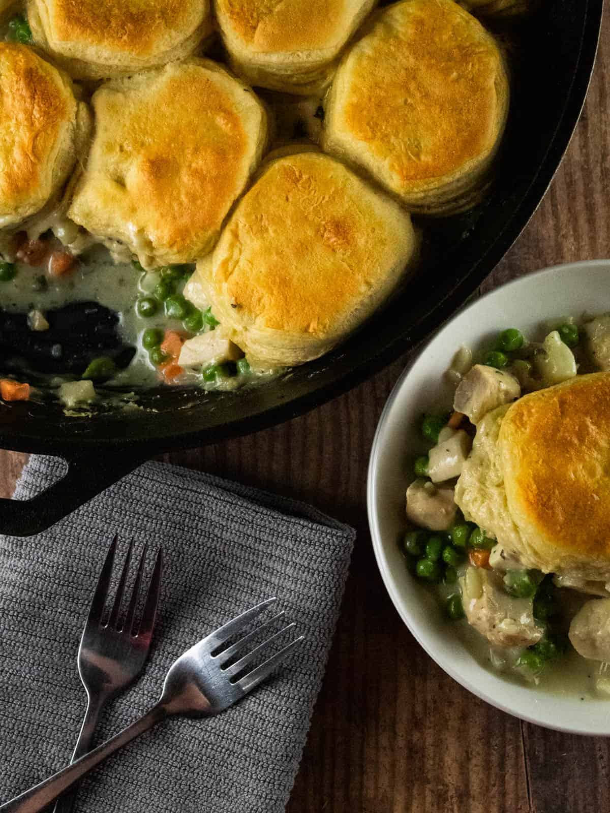 cast iron skillet and white plate with chicken pot pie