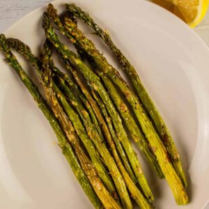 baked asparagus on a white plate