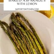baked asparagus with lemon on a white plate