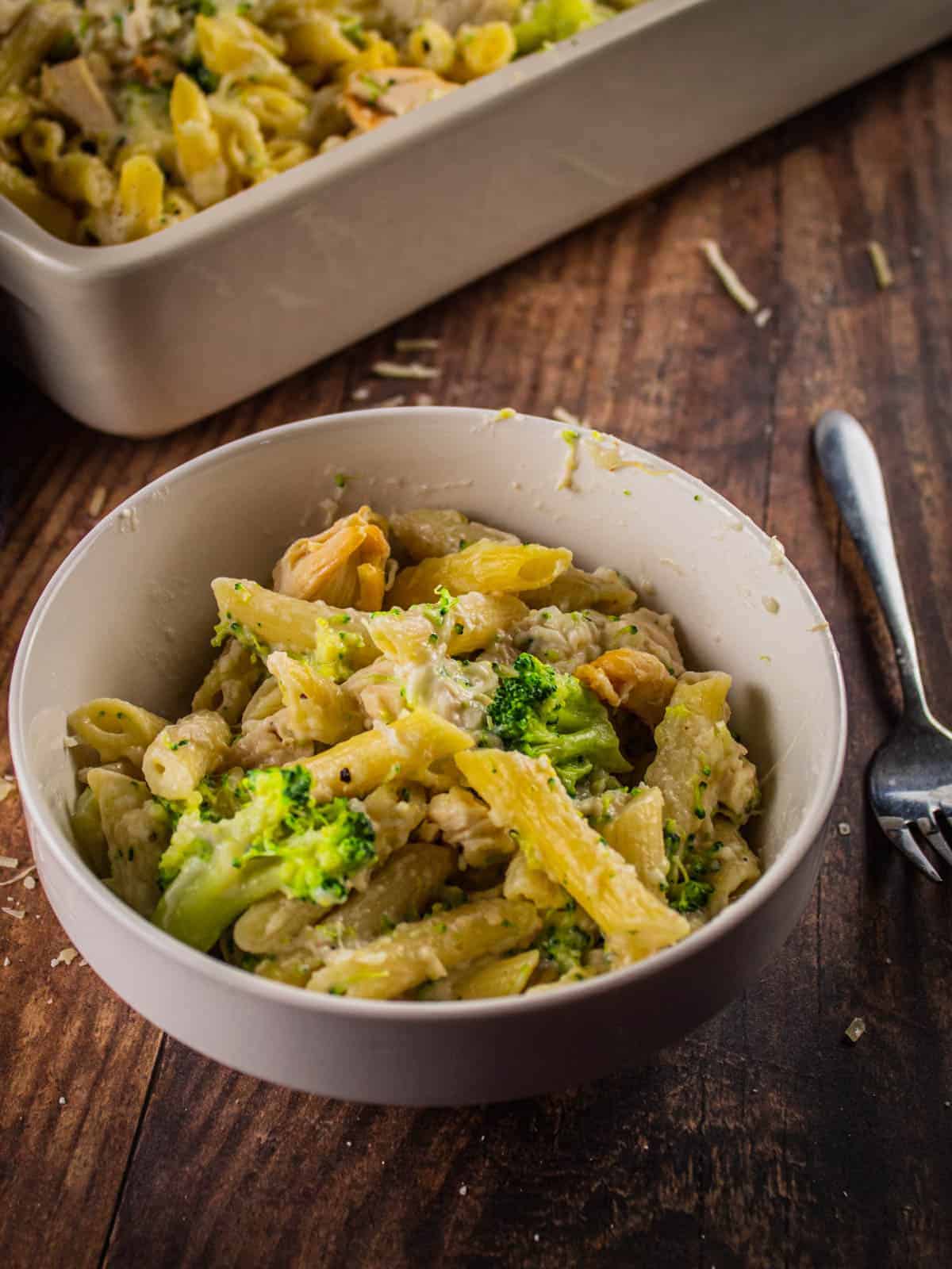 chicken and broccoli pasta with alfredo sauce in a white bowl