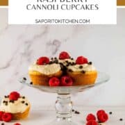 cannoli cupcakes on a stand with fresh raspberries
