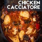chicken cacciatore in a crock pot with mushrooms, tomatoes and peppers.