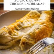 white cheese and chicken enchiladas on a plate with a fork