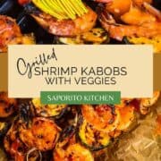 brush basting shrimp and vegetable kabobs on the grill