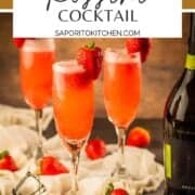champagne flutes with prosecco and strawberry puree and fresh strawberry garnish