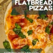 flatbread pizza on a sheet pan topped with sauce, cheese and fresh basil