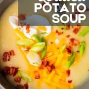 close up shot of a bowl of potato soup with bacon, green onions, cheddar cheese and sour cream.