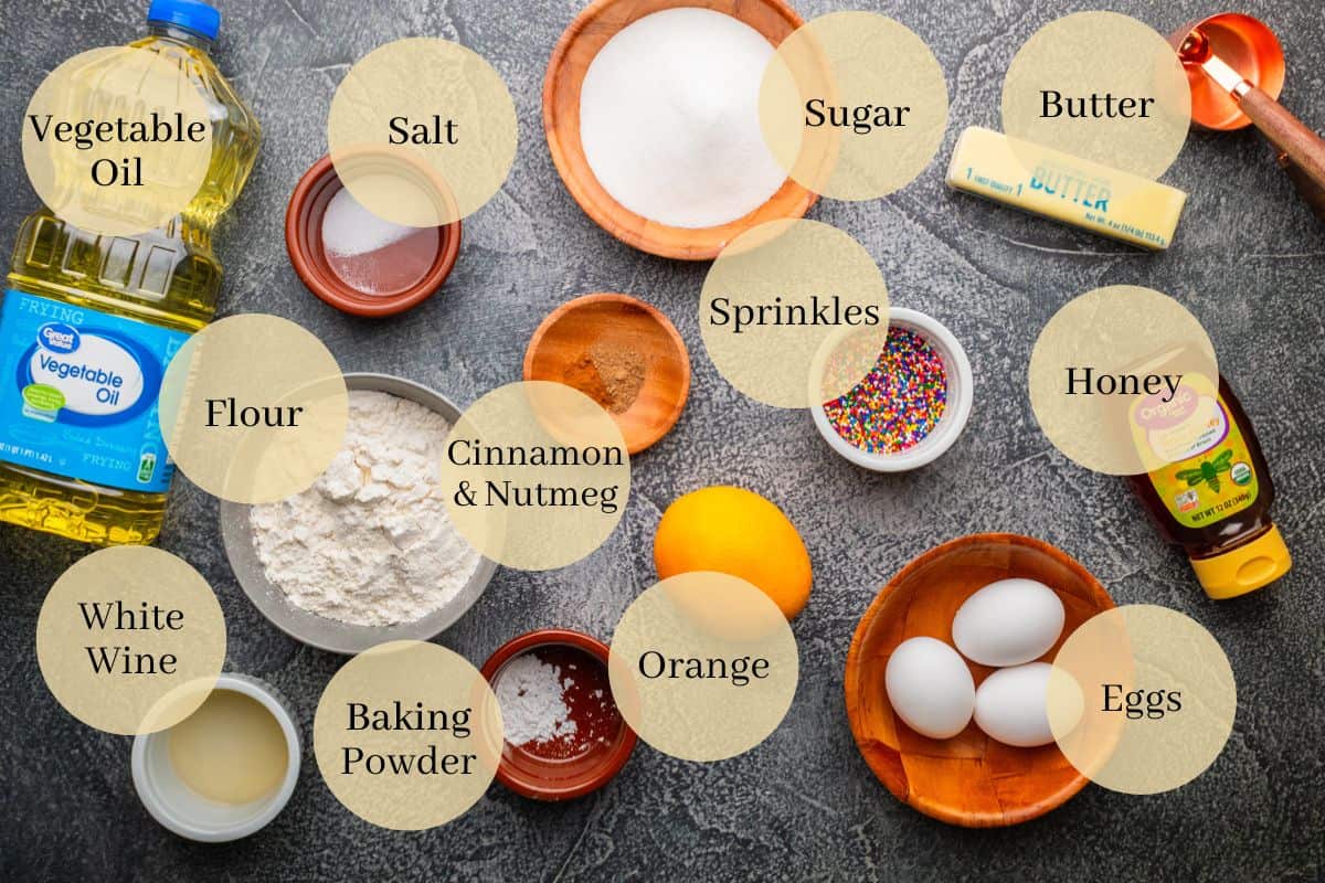 oil, salt, flour, wine, baking powder, cinnamon, nutmeg, orange, sugar, sprinkles, eggs, honey and butter.