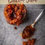 mason jar and spoon filled with tomato bacon jam.