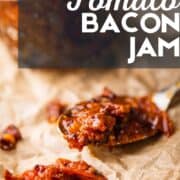 spoon of tomato bacon jam on crinkled parchment paper.